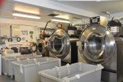 Room with three industial washing machines