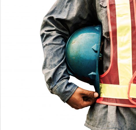 Construction man holding hat to his side
